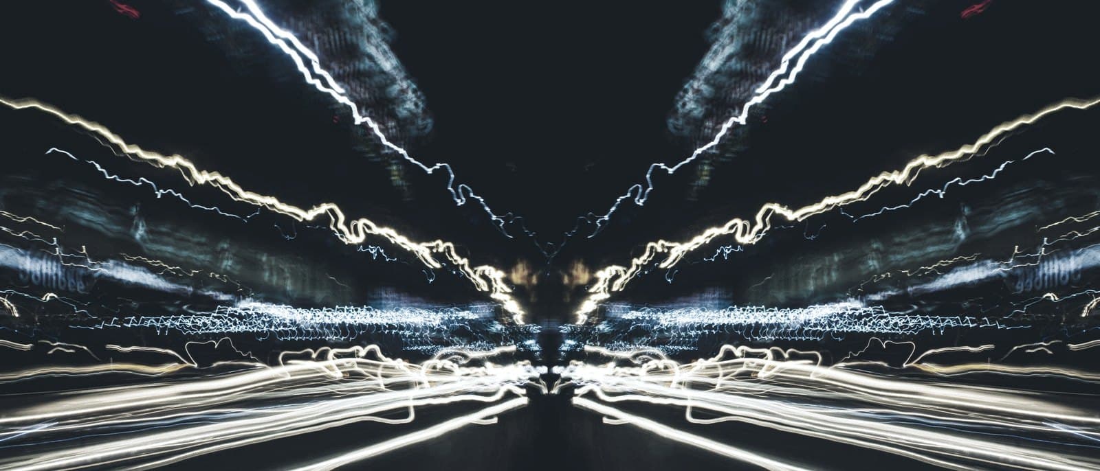Abstract light trails moving forward through the dark — the AI journey